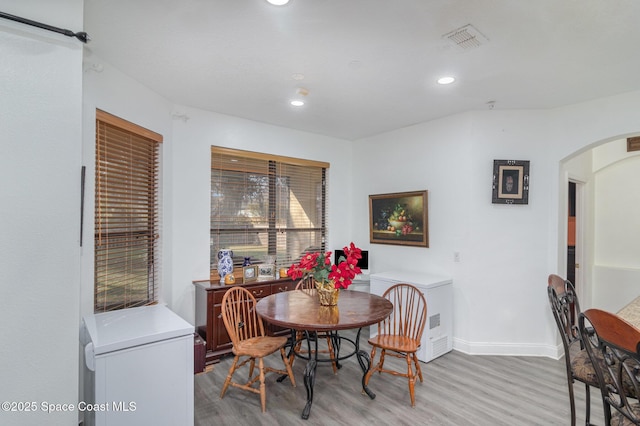 dining area featuring light wood-type flooring