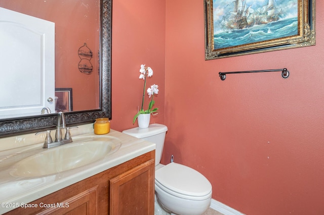 bathroom with toilet and vanity