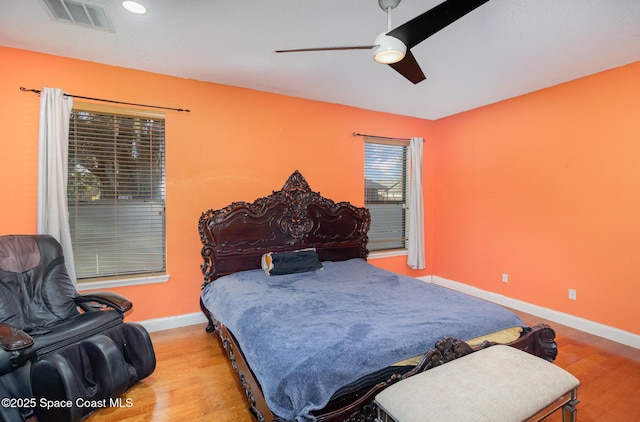 bedroom with ceiling fan and light hardwood / wood-style flooring