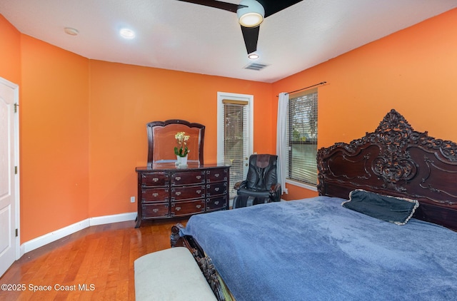 bedroom with ceiling fan and hardwood / wood-style floors