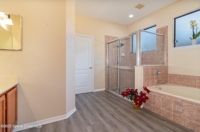 bathroom featuring separate shower and tub, vanity, and wood-type flooring