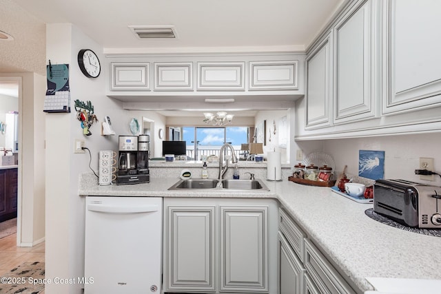 kitchen with dishwasher, sink, tile patterned floors, a chandelier, and gray cabinets