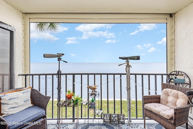 balcony featuring a water view