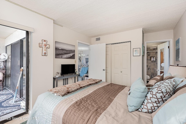 bedroom featuring access to outside, a closet, a chandelier, and a textured ceiling