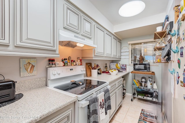 kitchen with white range with electric cooktop, light stone counters, light tile patterned floors, and range hood