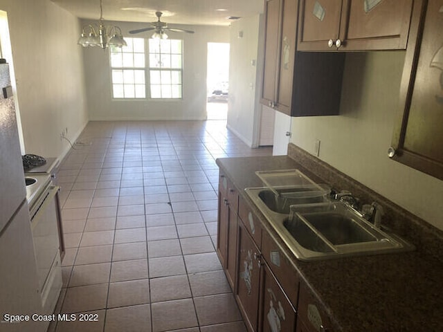 kitchen with ceiling fan with notable chandelier, sink, white electric stove, and light tile patterned flooring