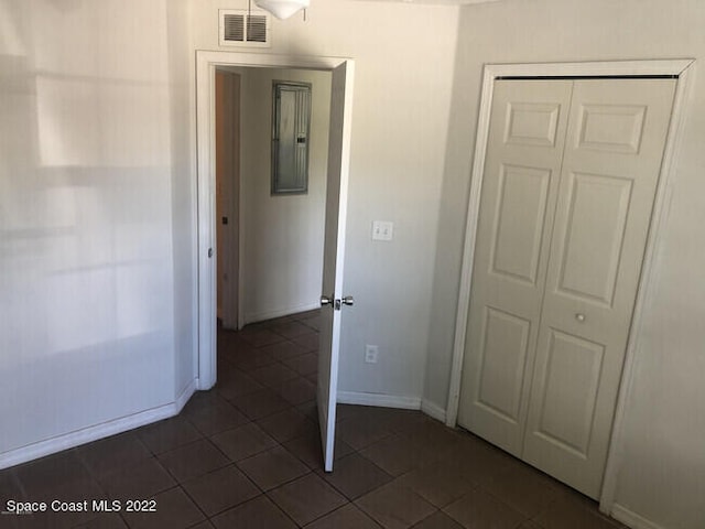 hallway with dark tile patterned floors