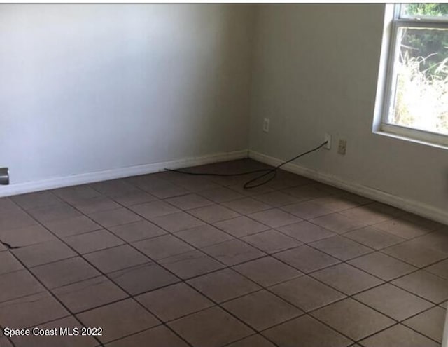 spare room featuring tile patterned flooring