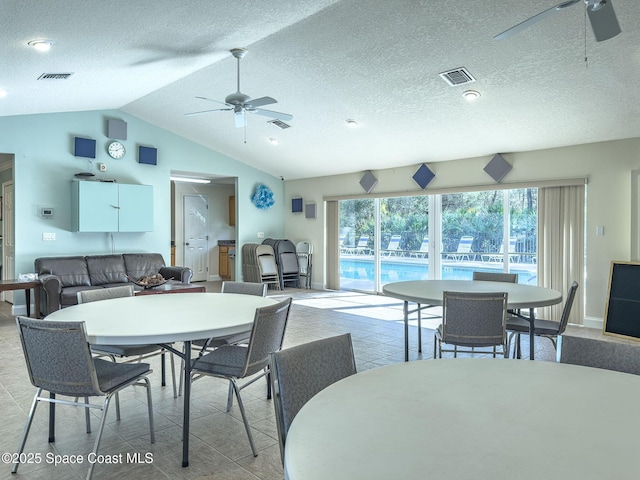 dining space with ceiling fan and lofted ceiling