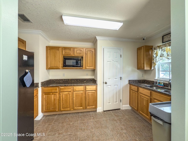 kitchen featuring black appliances, ornamental molding, sink, and a textured ceiling