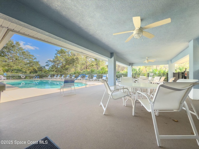 view of patio featuring ceiling fan and a community pool