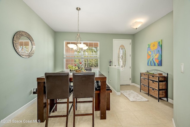 dining space featuring a notable chandelier and light tile patterned floors