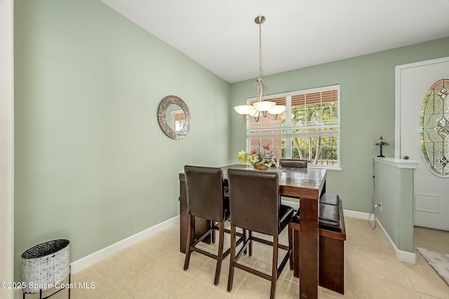 tiled dining room with a notable chandelier