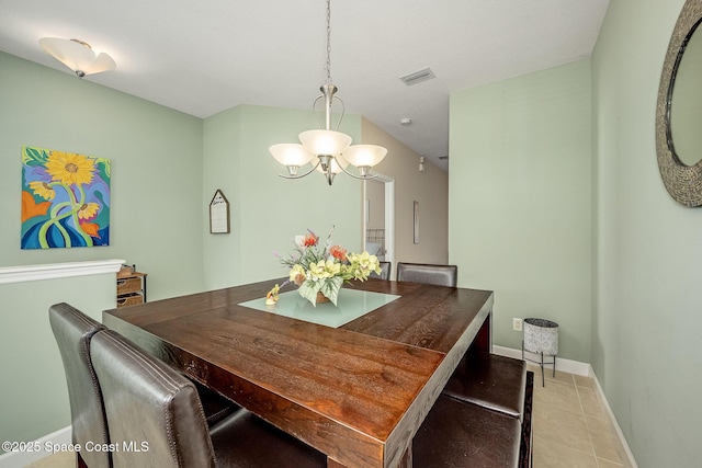 tiled dining space featuring an inviting chandelier