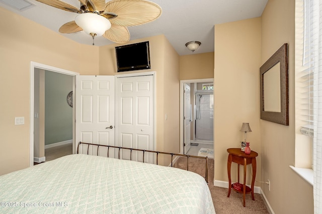 bedroom with carpet flooring, ceiling fan, ensuite bathroom, and a closet