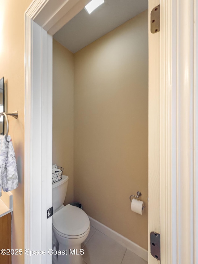 bathroom featuring tile patterned flooring and toilet