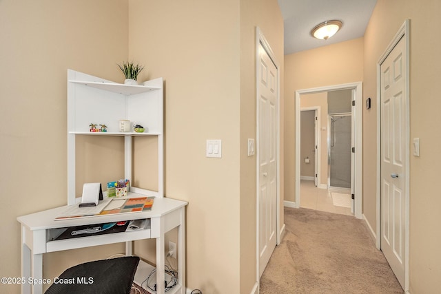 hall featuring light colored carpet