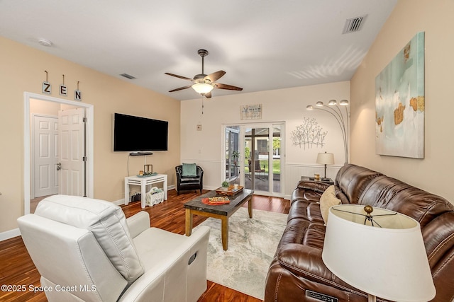 living room featuring ceiling fan and dark hardwood / wood-style flooring