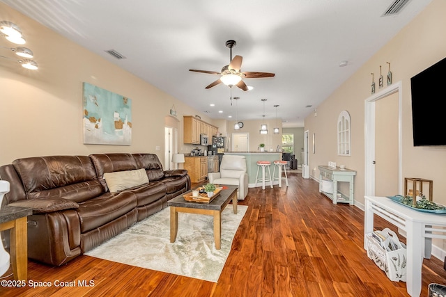 living room featuring ceiling fan and wood-type flooring