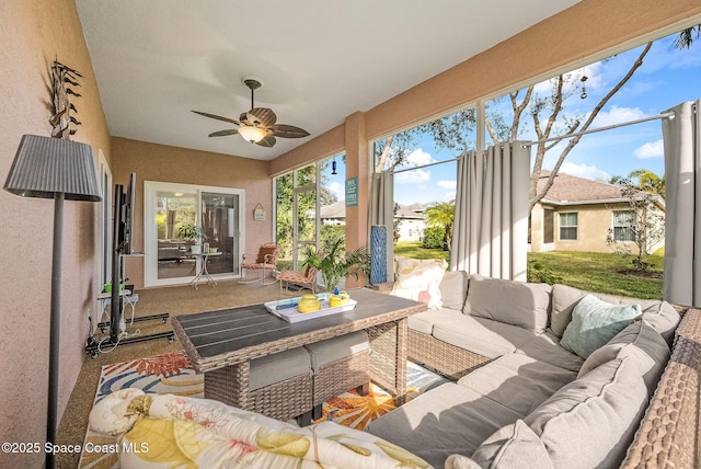 sunroom featuring ceiling fan