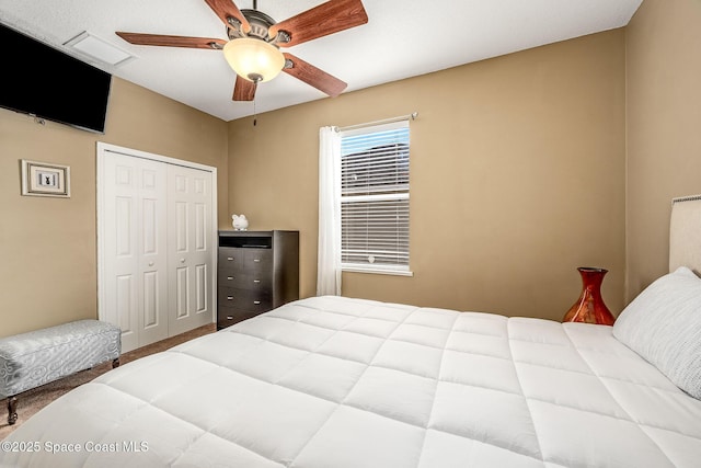 bedroom featuring ceiling fan and a closet