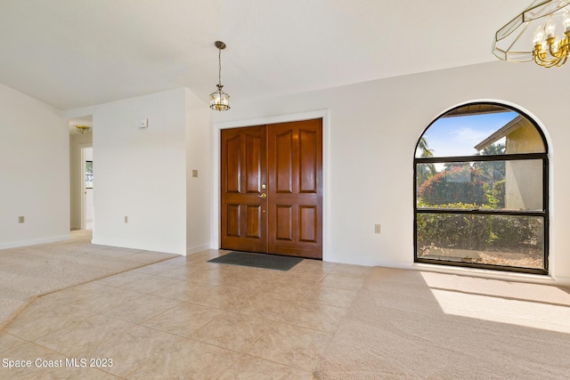 foyer entrance featuring light tile patterned floors and a chandelier