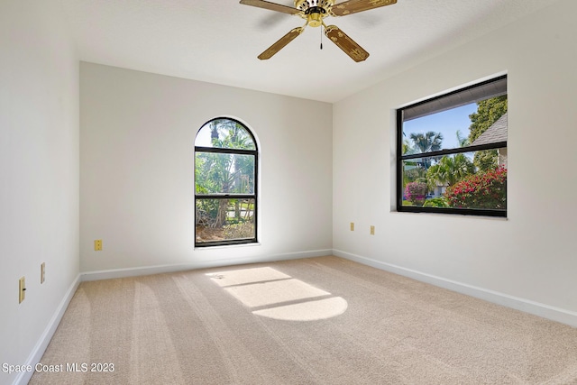 spare room with carpet floors and ceiling fan