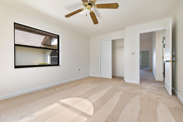 unfurnished bedroom featuring a closet, light colored carpet, and ceiling fan