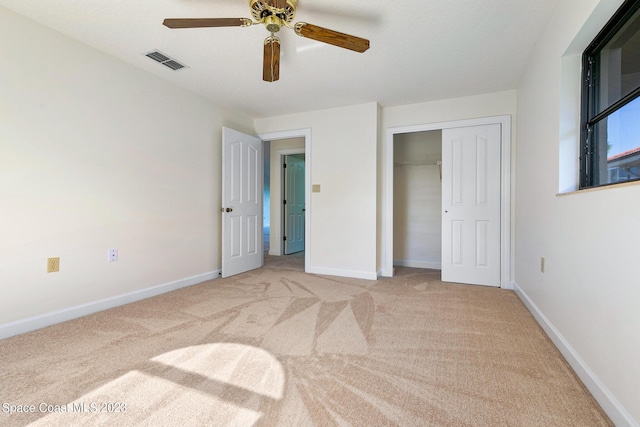 bedroom featuring ceiling fan, a closet, and light carpet