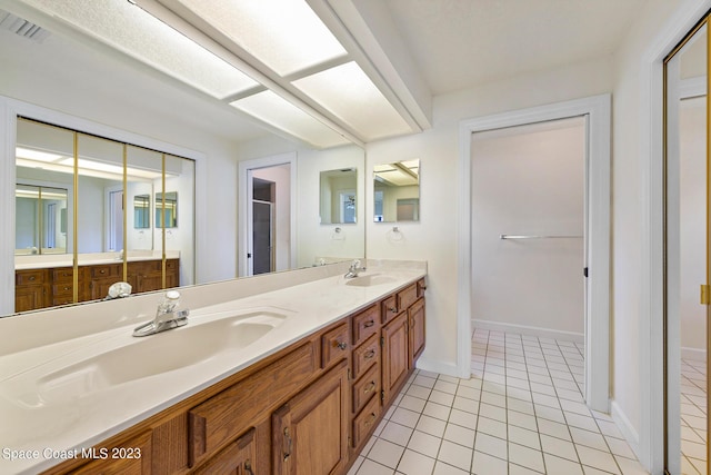 bathroom with tile patterned flooring and vanity