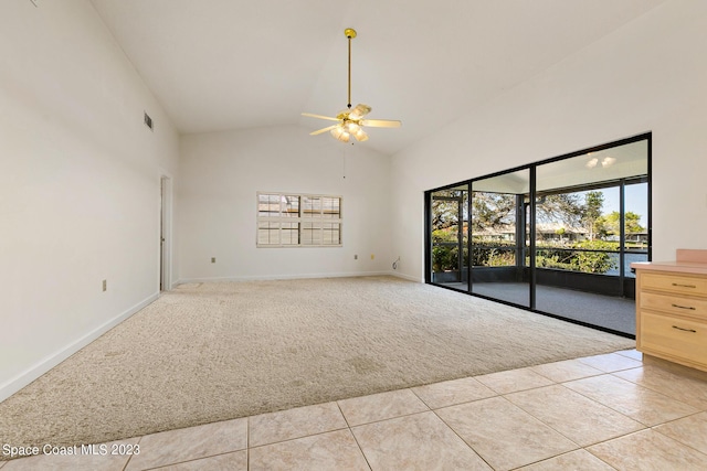 spare room featuring ceiling fan, light tile patterned flooring, and high vaulted ceiling