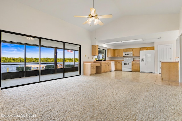 kitchen featuring ceiling fan, plenty of natural light, light colored carpet, and white appliances