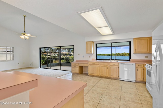 kitchen featuring white appliances, ceiling fan, light brown cabinets, light tile patterned floors, and plenty of natural light