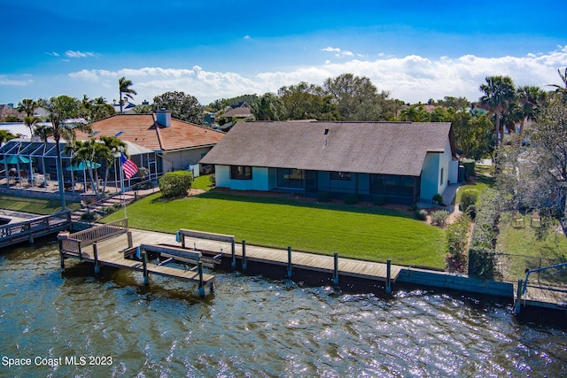 rear view of property with a lawn and a water view