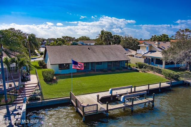 dock area with a lawn and a water view