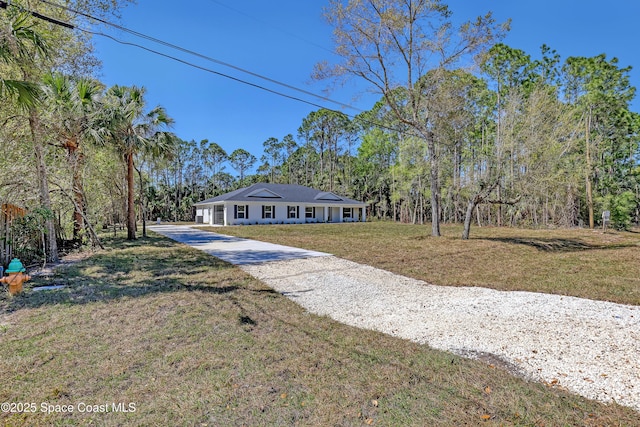 ranch-style home featuring driveway and a front yard