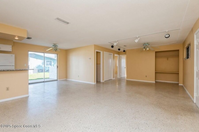 unfurnished living room with ceiling fan and track lighting