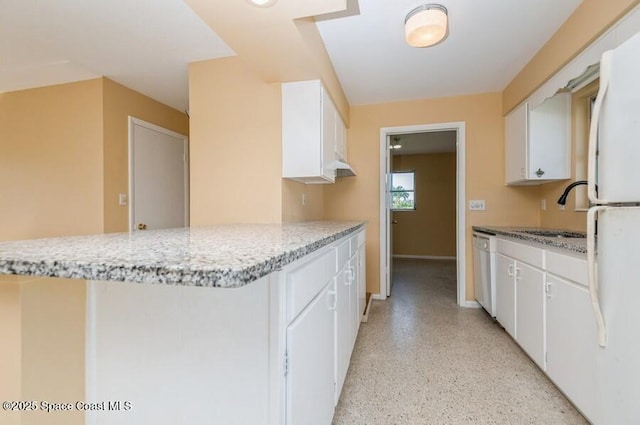 kitchen with sink, light stone counters, kitchen peninsula, white dishwasher, and white cabinets