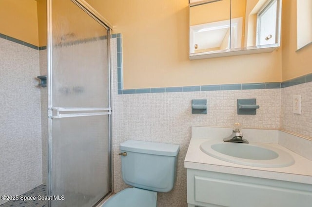 bathroom with vanity, toilet, walk in shower, and tile walls