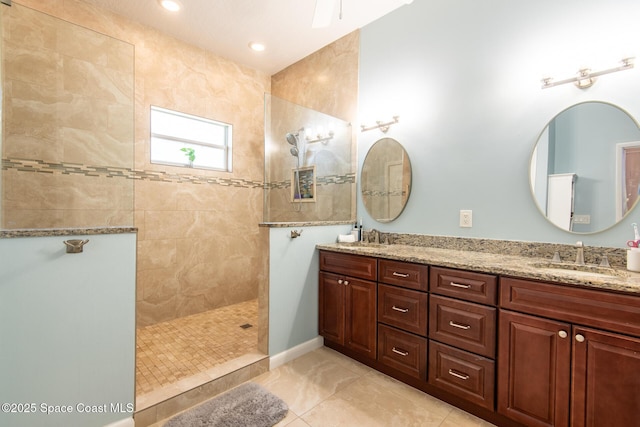 bathroom with tile patterned floors, vanity, and tiled shower