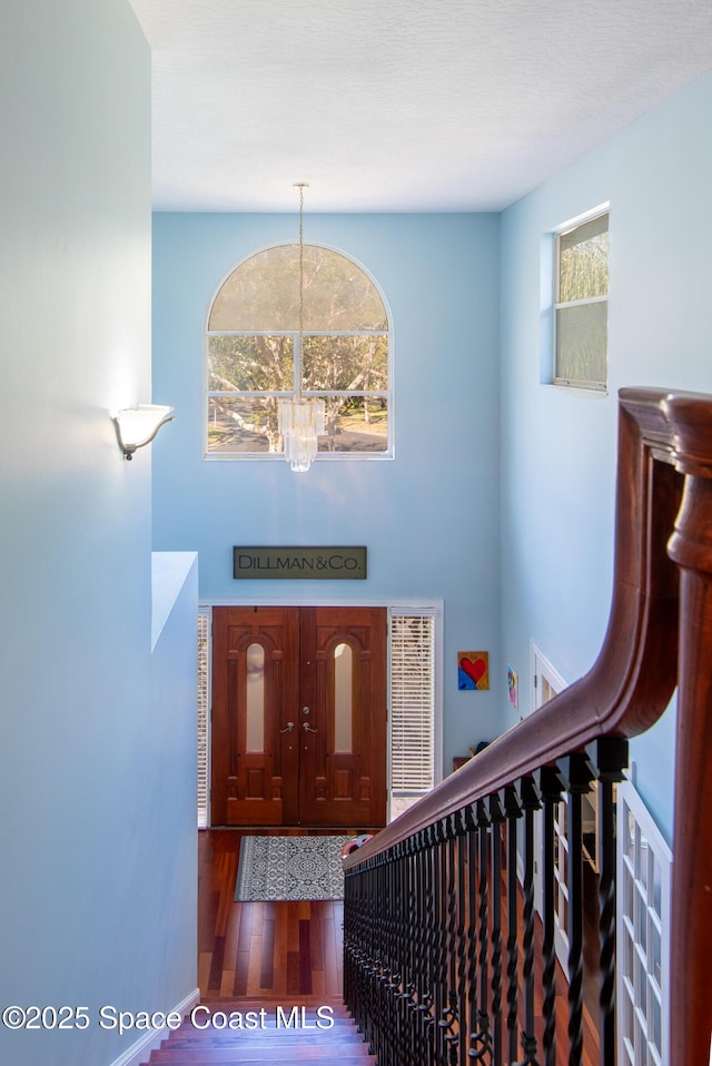 foyer featuring a chandelier and dark hardwood / wood-style flooring