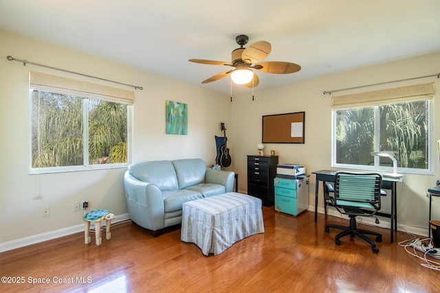 home office with hardwood / wood-style flooring and ceiling fan