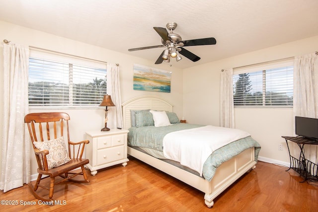 bedroom with light wood-type flooring and ceiling fan