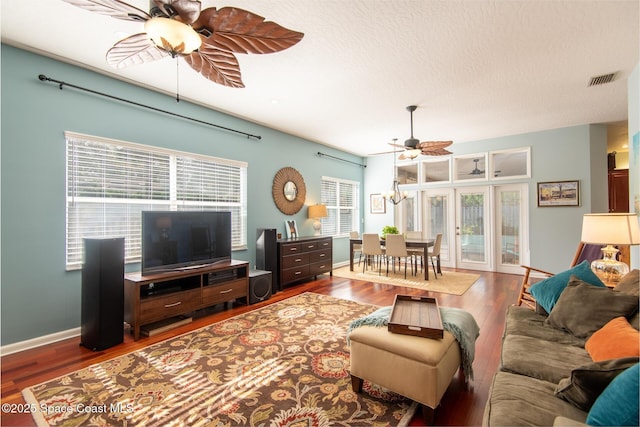 living room featuring a wealth of natural light, ceiling fan, a textured ceiling, and hardwood / wood-style flooring