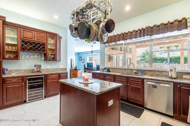 kitchen with stainless steel dishwasher, ceiling fan, a healthy amount of sunlight, sink, and wine cooler