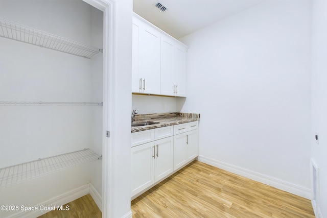 interior space featuring sink and light hardwood / wood-style flooring