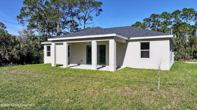 rear view of property with a lawn and a patio area