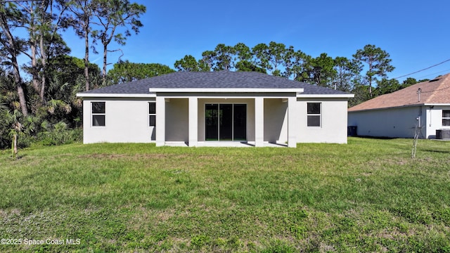 rear view of property featuring a yard