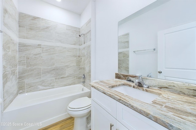 full bathroom with tiled shower / bath combo, toilet, and vanity