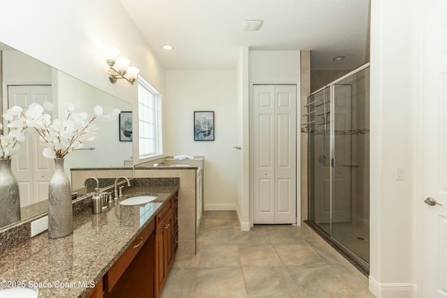 bathroom with a shower with door and vanity